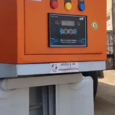 A white-bodied floor-standing unit on a fabricated base, with an orange-fronted control fascia carrying three indicator lamps, a display and a rotary switch. A Jayess & Co. label is fixed to the base.